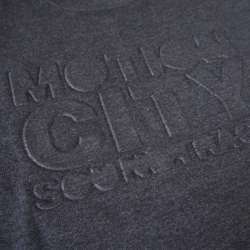 Dark grey crewneck with MOTION CITY SOUNDTRACK in embossed lettering on the chest